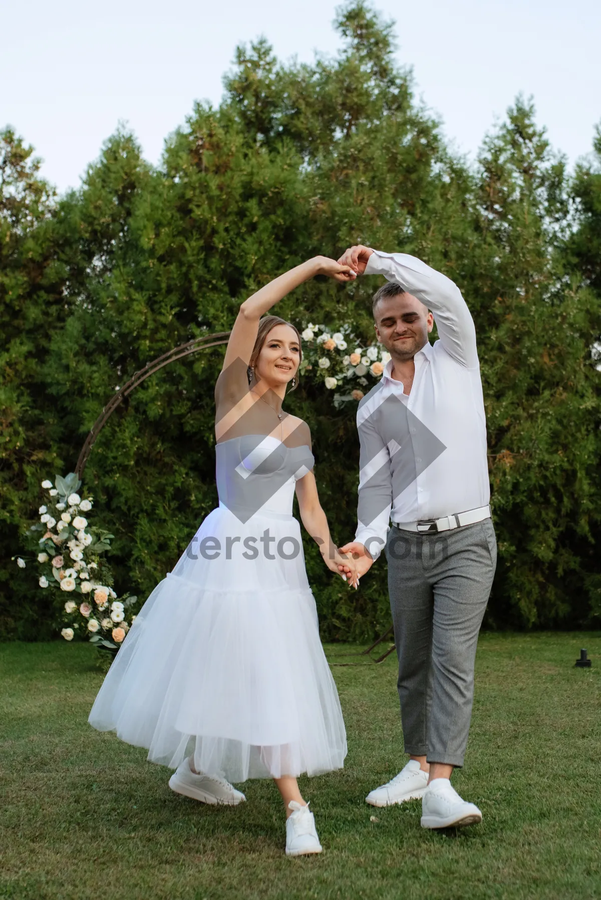 Picture of Happy bride and groom celebrating in park