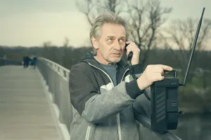 Happy male executive with laptop outdoors