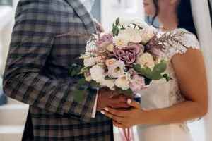 Happy Bride and Groom with Floral Bouquet