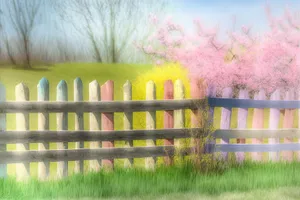 Rural landscape with barn and picket fence.