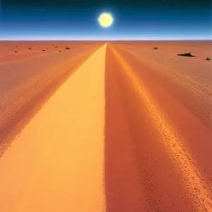 Sunlit Dunes: Desert Landscape with Asphalt Road and Vibrant Sky