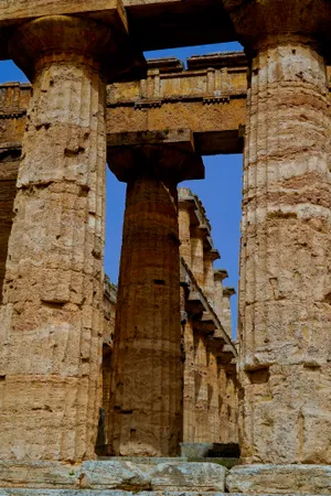 Ancient Roman temple ruins against a clear blue sky