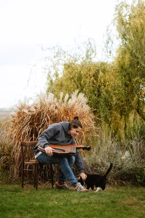 Happy farmer harvesting wheat in the countryside field.