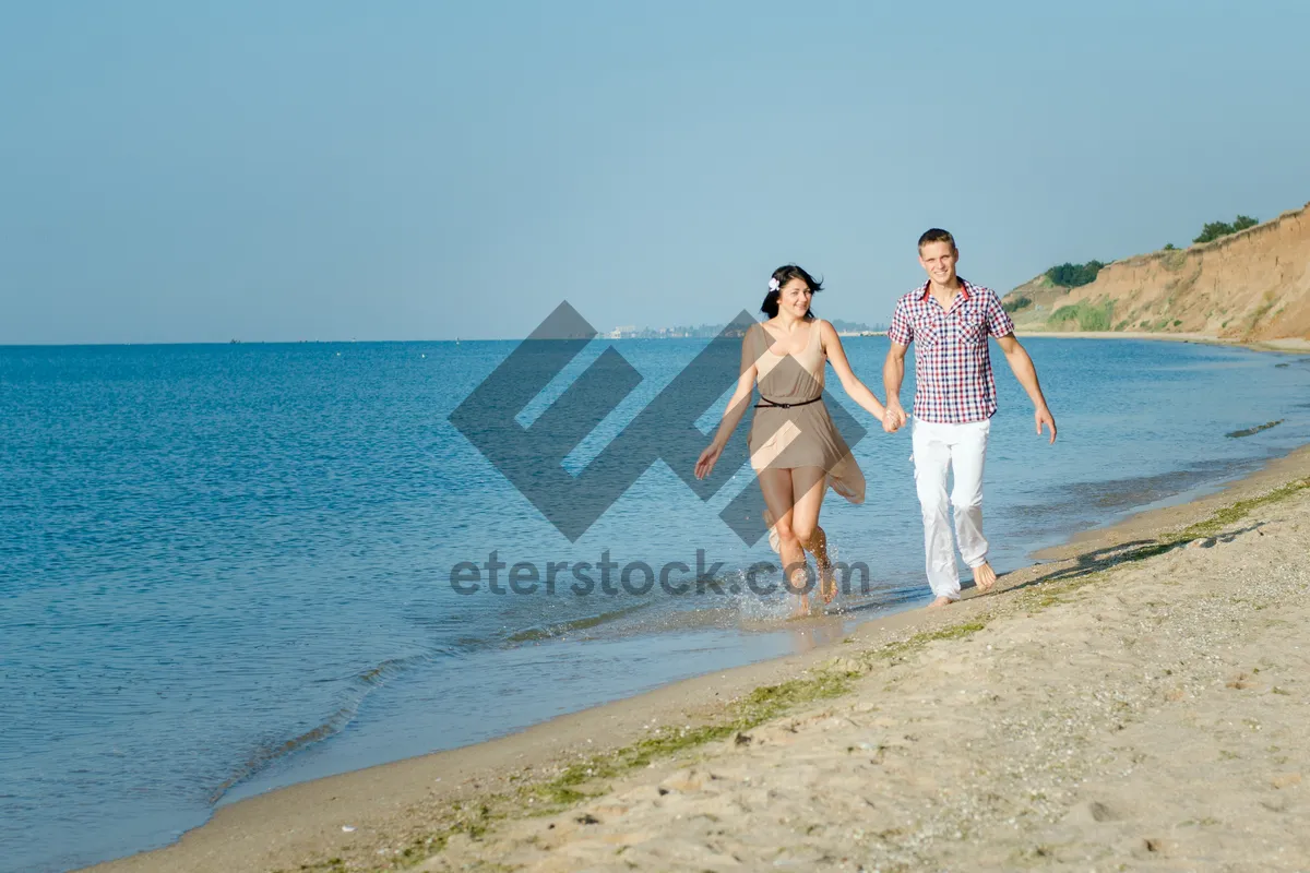 Picture of Happy couple on tropical island beach shore.