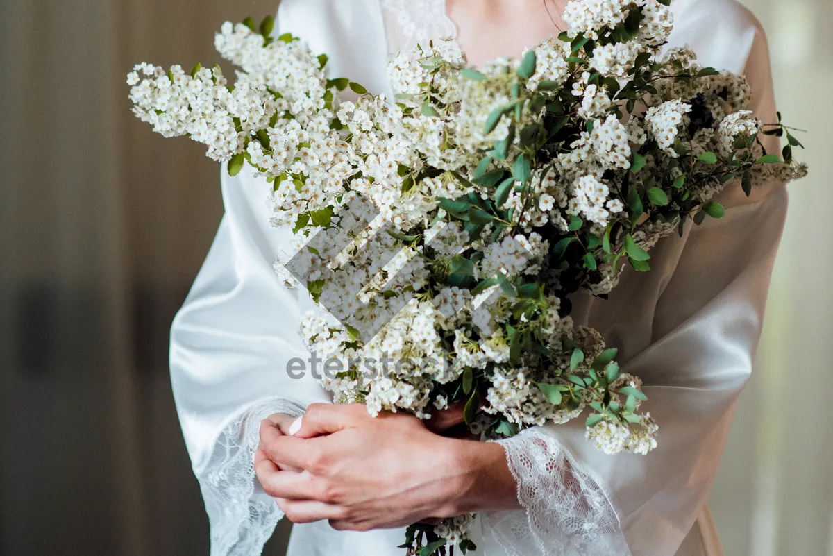 Picture of Happy couple at wedding with rose bouquet