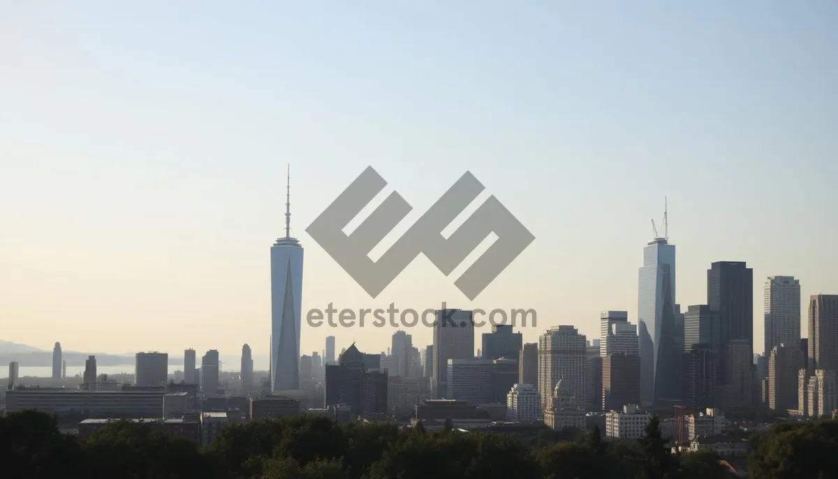 Picture of Modern office tower overlooking city skyline at sunset.