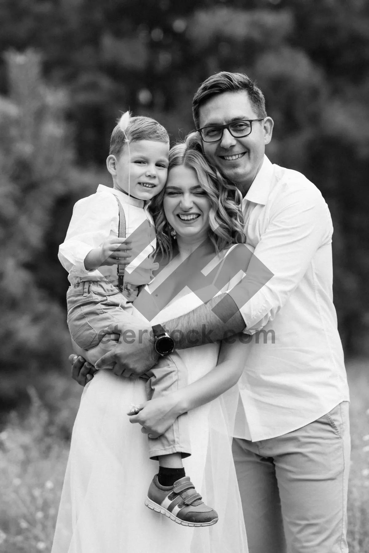 Picture of Happy family portrait in the park outdoor setting.