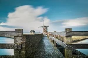 Historic Bridge Over River in City Landscape Skyline