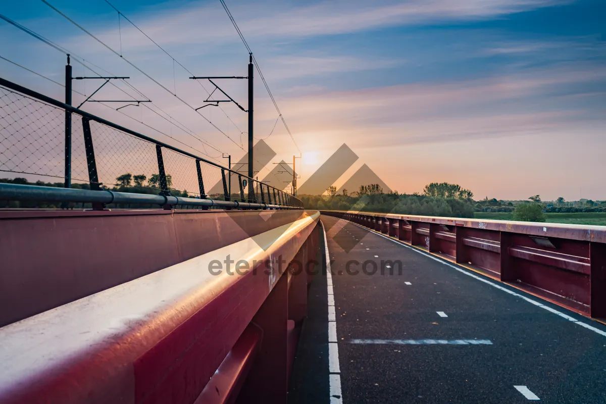 Picture of Urban Skyline with Highway and Bridge at Sunset