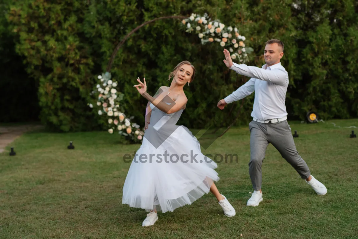 Picture of Happy couple newlyweds smiling in summer park celebration.