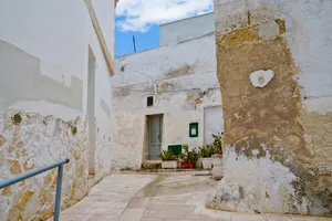 Medieval stucco house with brick walls in urban area