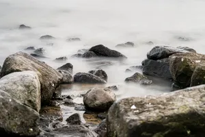 Wave-breaking rocks at coastal shoreline