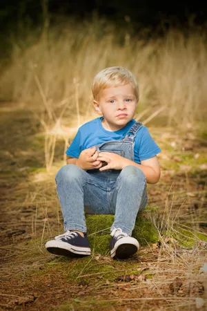 Happy boy playing soccer ball in the park