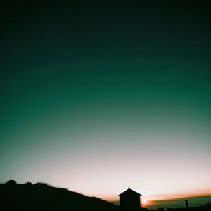 Golden Horizon: Rural Sunrise on Meadow with Barn