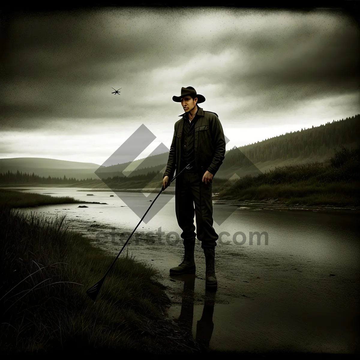 Picture of Sunset silhouette of man with metal detector on beach