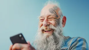 Elderly man with gray beard and mustache smiling