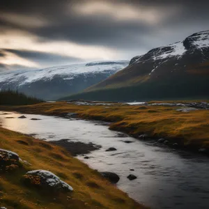 Rocky coast at sunset with snowy mountain view.