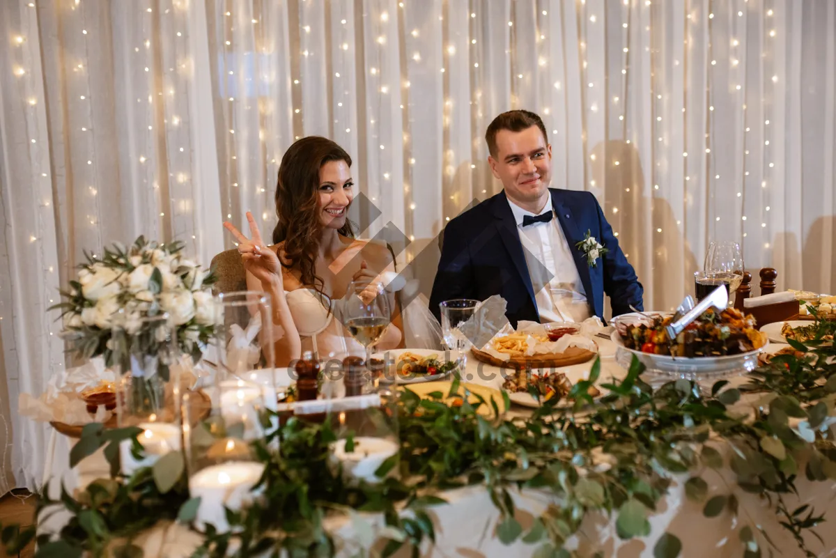 Picture of Happy friends enjoying dinner together at restaurant table.