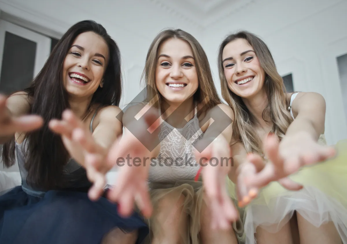 Picture of Happy young friends smiling and relaxing at home.