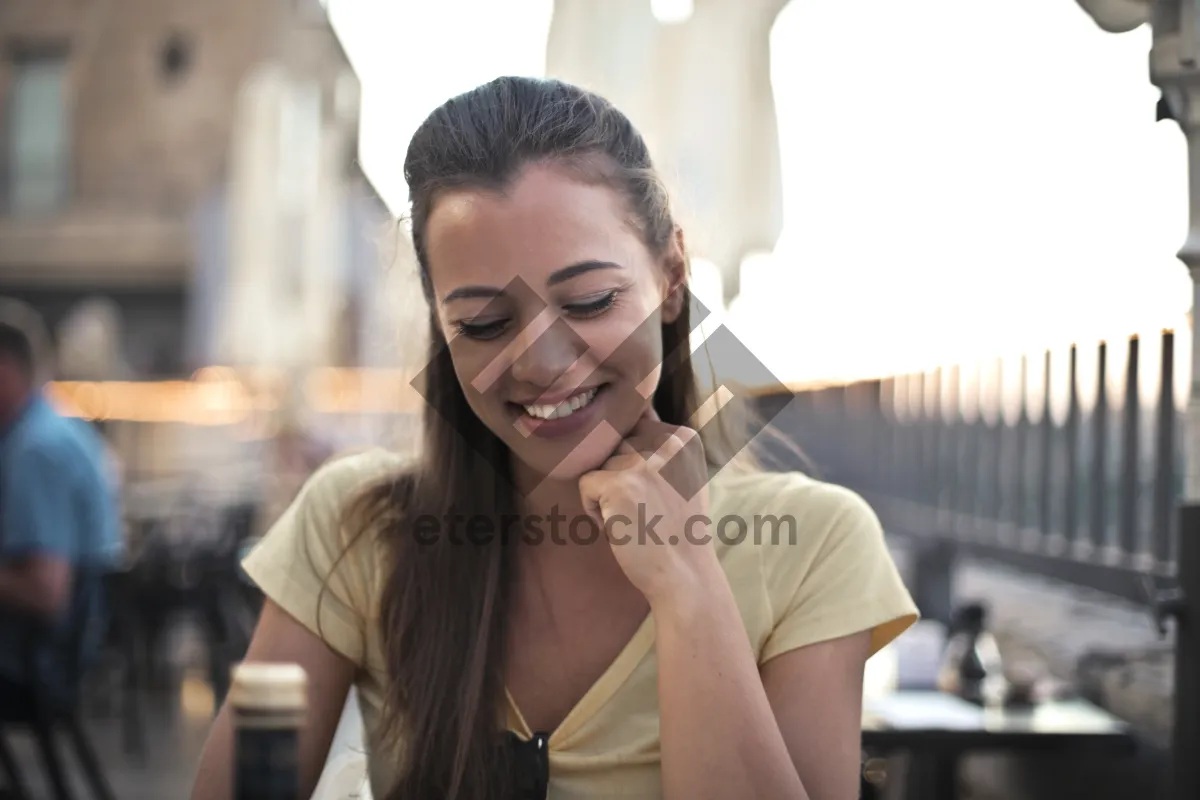 Picture of Smiling businesswoman in corporate office using phone