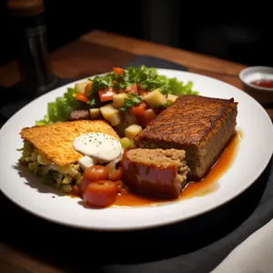 Grilled steak with vegetable salad and sauce.