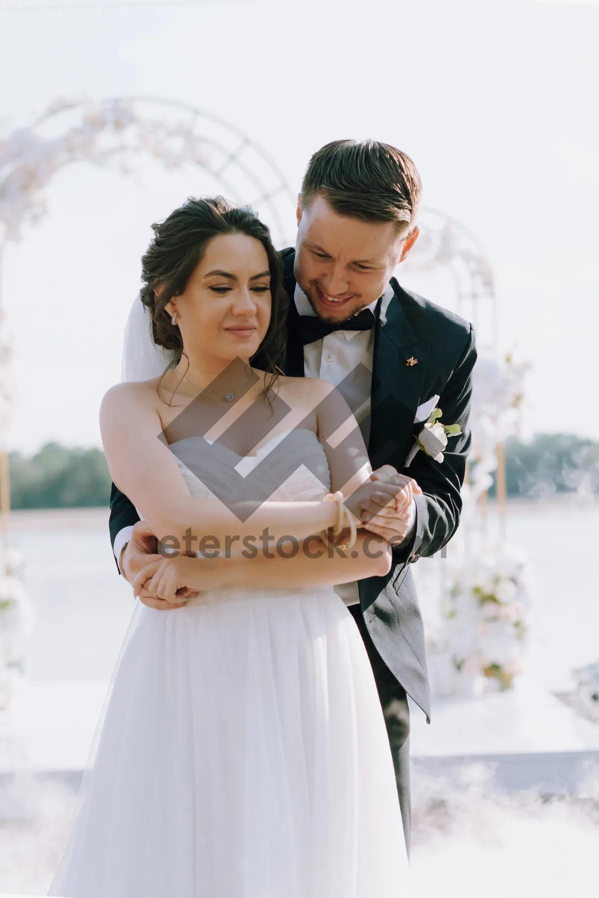 Picture of Happy Wedding Couple Smiling with Bouquet