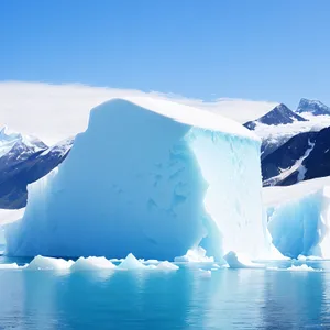 Majestic Arctic Landscape: Iceberg Amongst Frozen Mountains