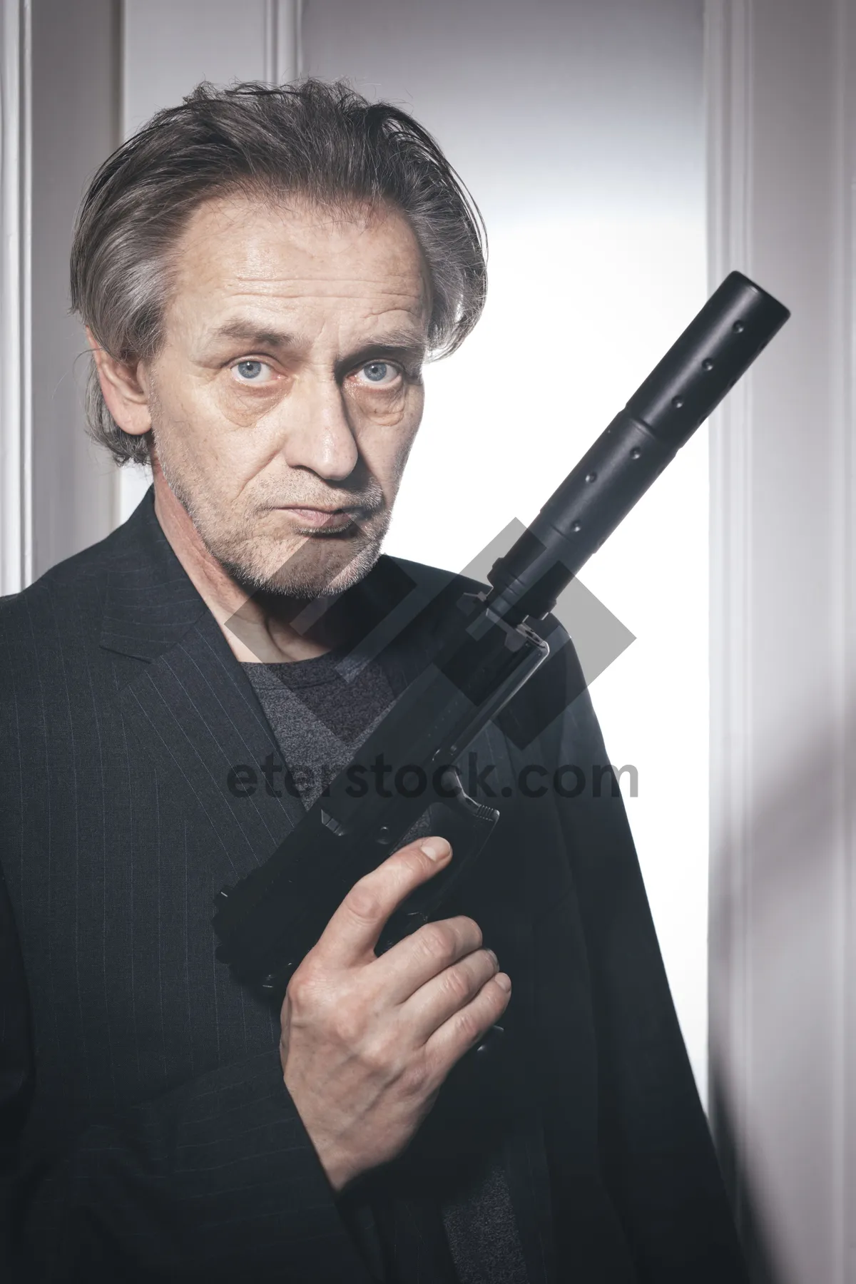 Picture of Black businessman executive portrait with gun