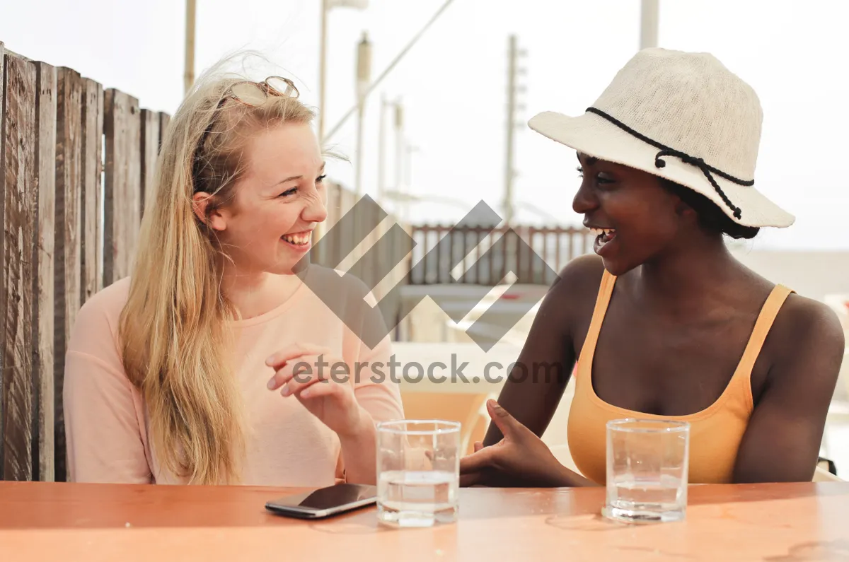 Picture of Happy couple sitting together at home smiling