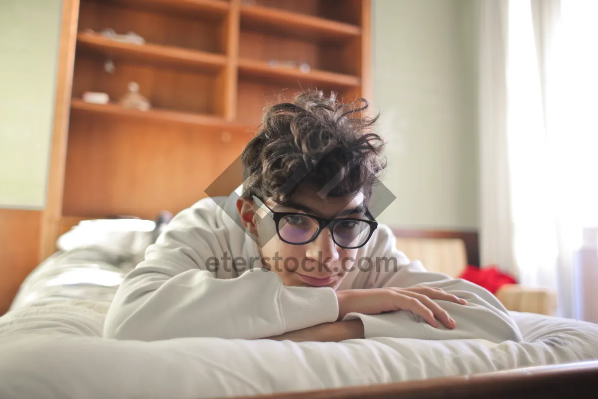 Picture of Smiling man in bed wearing goggles