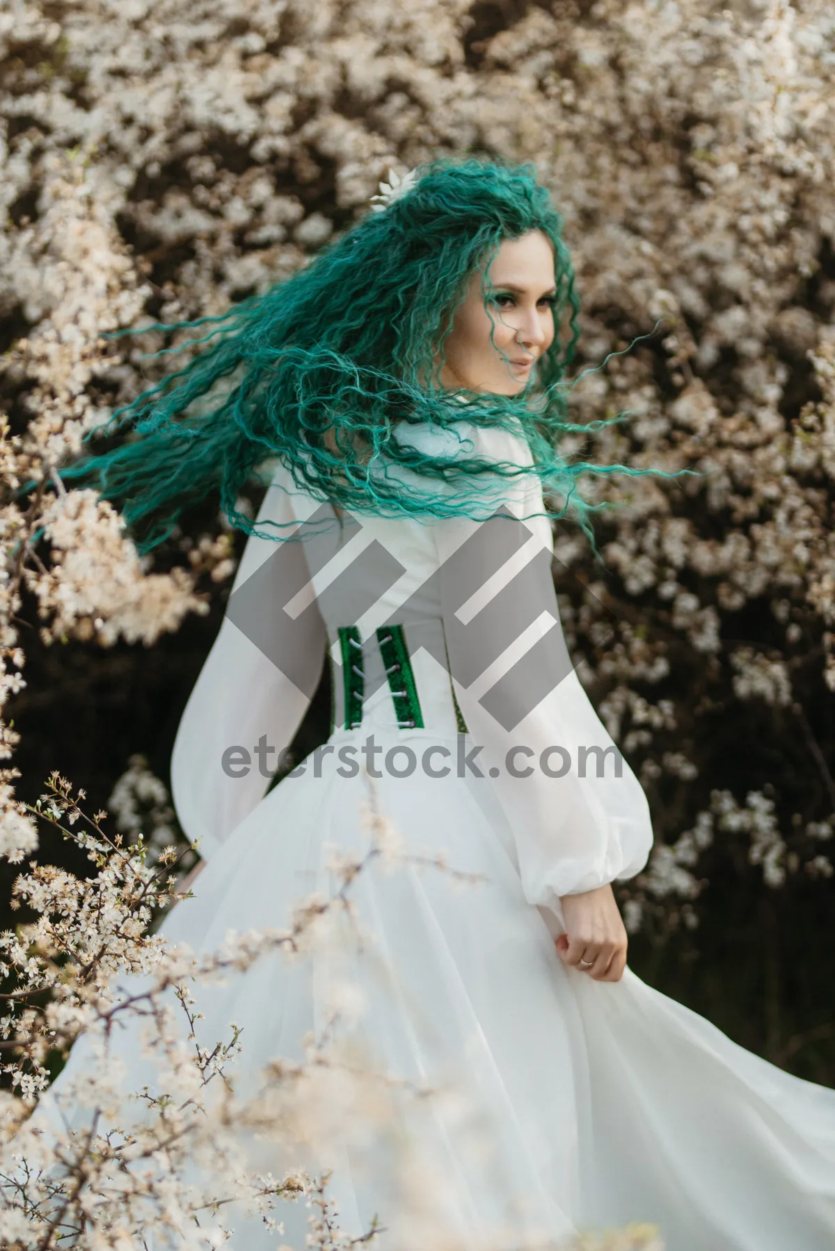 Picture of Attractive bride in summer wedding dress smiling happily.