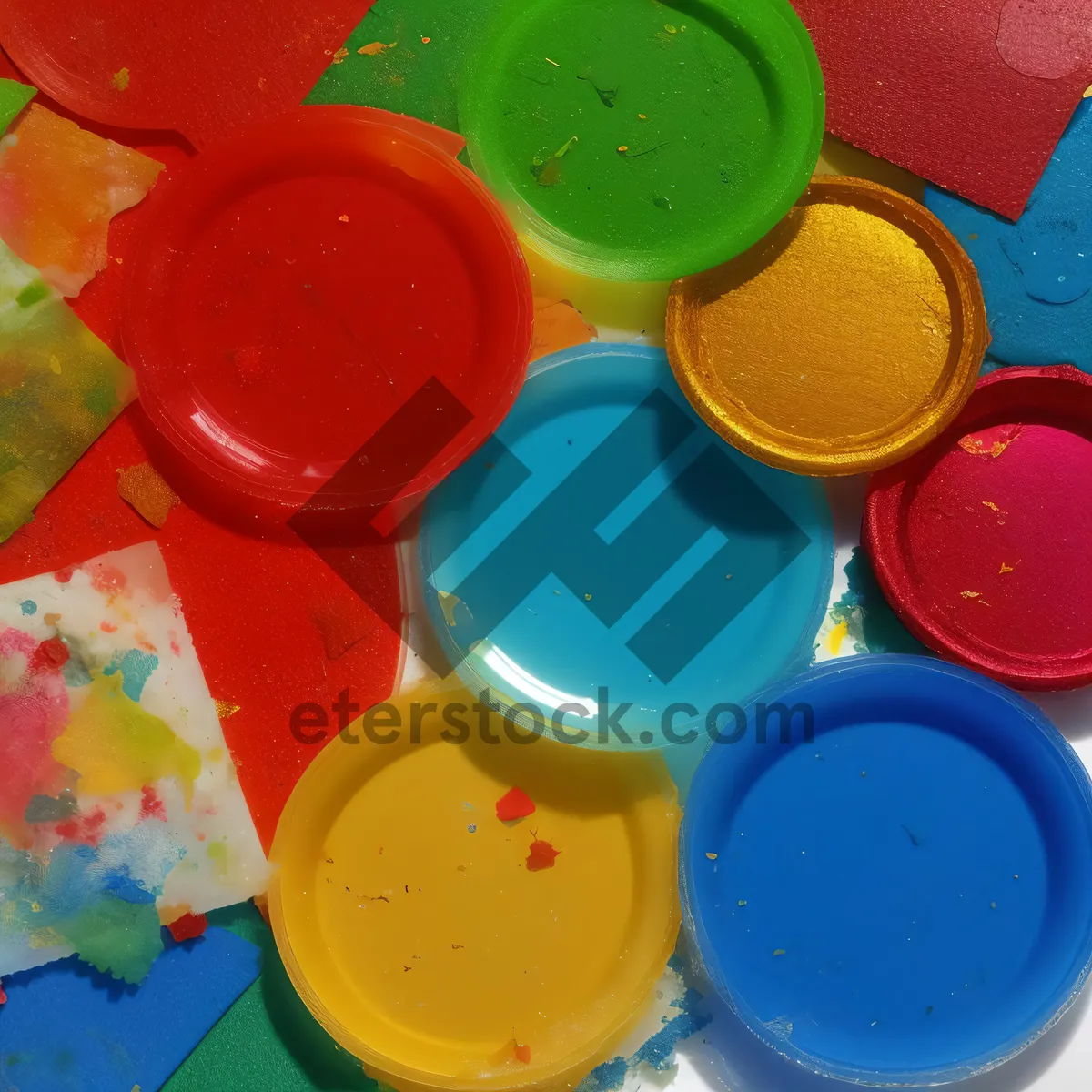 Picture of Colorful paint bottles in yellow container on counter tray.