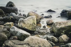 Skyline view of coastal rock barrier by the sea.