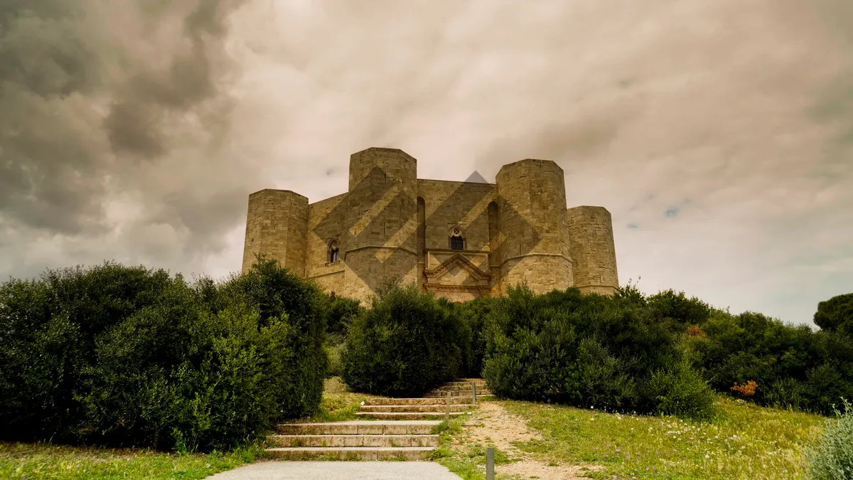 Picture of Medieval castle overlooking scenic historical landscape & sky.