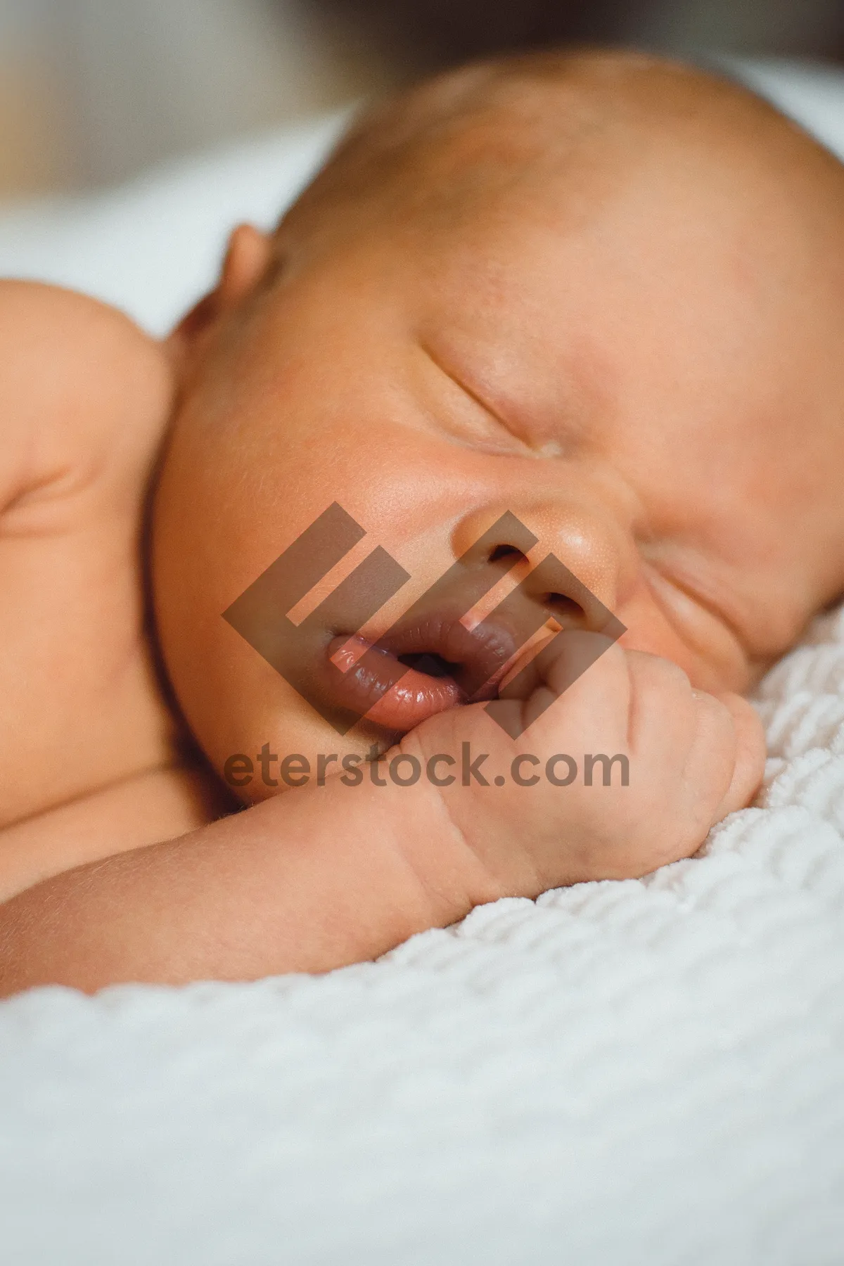 Picture of Adorable Baby Boy Smiling in Mother's Arms.