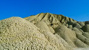 Mountain peak with stone wall barrier under blue sky