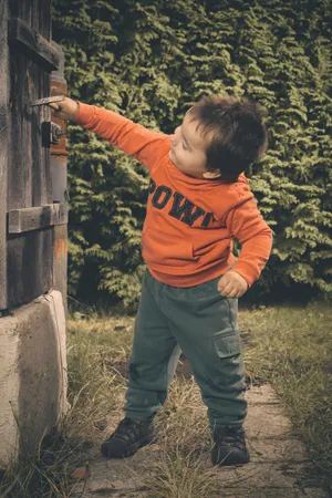 Happy boy playing with an air gun outdoors.