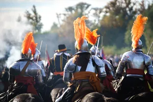 Male warrior holding a torch on horseback in battle