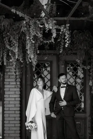 Portrait of adult groom posing with guillotine instrument.