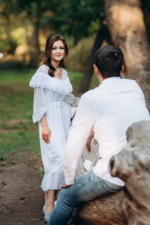 Happy newlywed couple in the park posing together joyfully