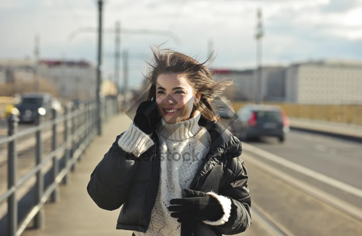 Picture of Attractive brunette lady in stylish coat smiling