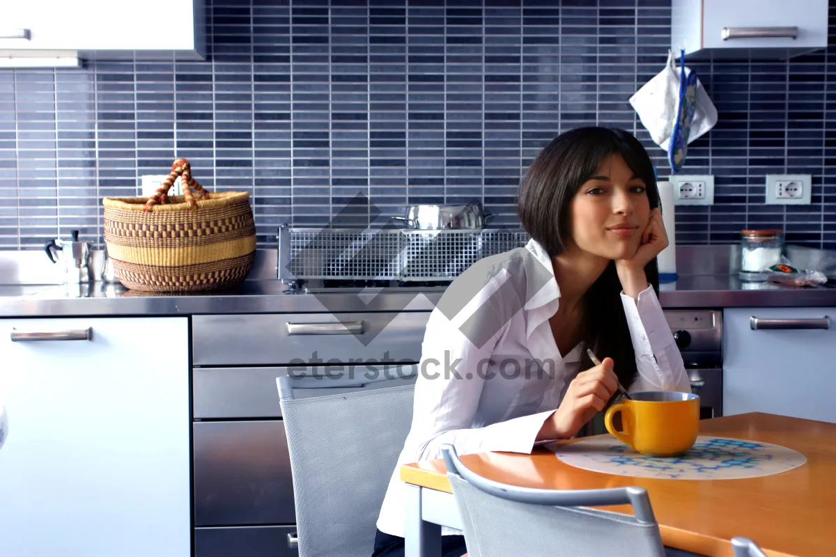 Picture of Happy businesswoman working on laptop in office