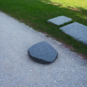 Stone Manhole Cover on Top of Sand-Covered Road