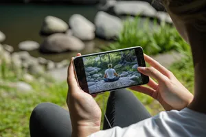 Hand holding digital device with communication screen technology.