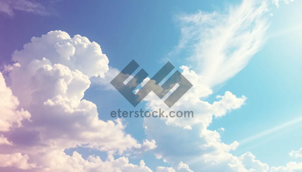 Picture of Bright summer sky with fluffy clouds and sunlight.