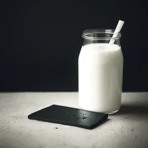 Healthy Milk in Glass Bottle with Salt Shaker