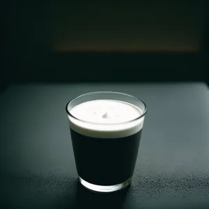 Milk-filled espresso mug on wooden table.