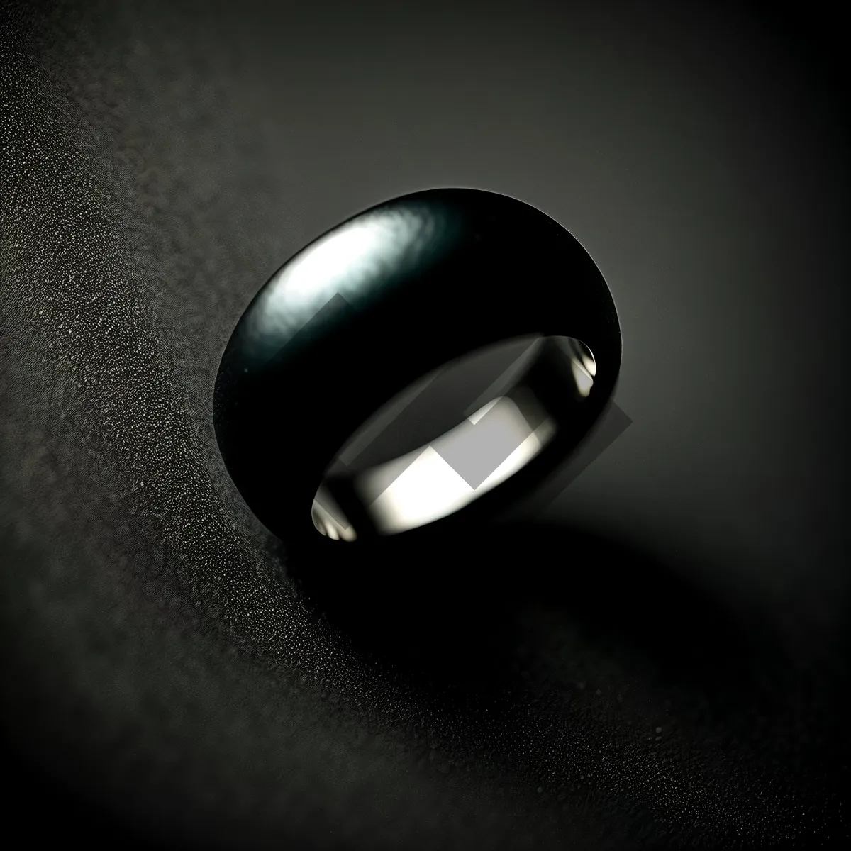 Picture of Elegant Black Ring with Reflection in Lamp Light