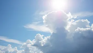 Vibrant summer sky with fluffy clouds and bright sun.