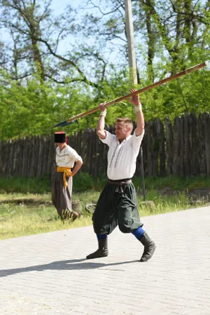 Man playing golf outdoors with support post